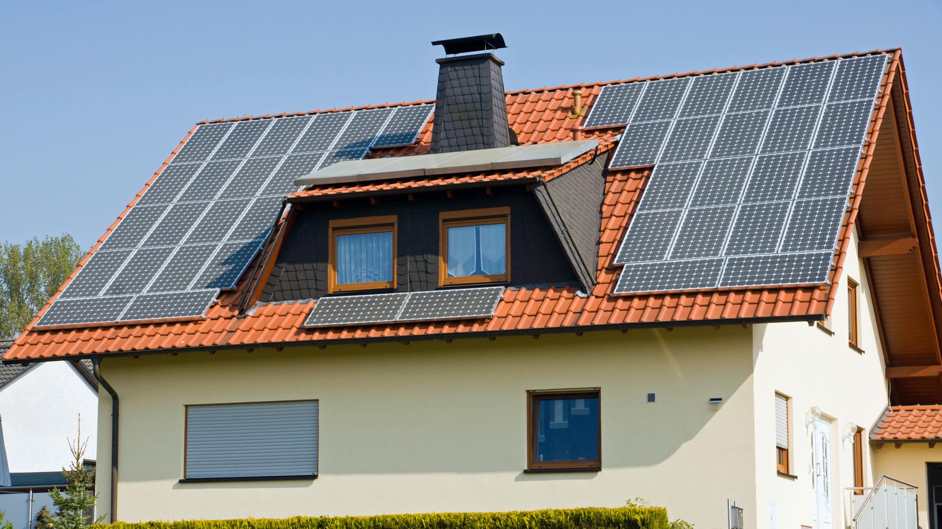 Freistehendes Haus mit Trapezgaube mit zwei Fenstern.