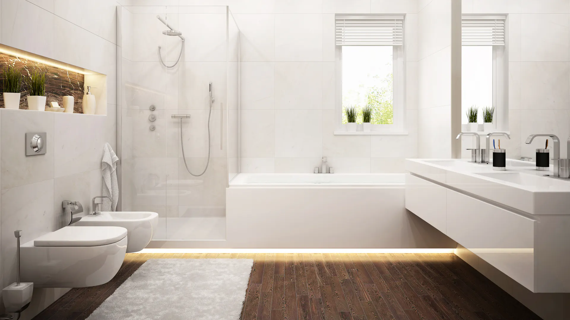 Un bagno moderno piastrellato di bianco con pavimento in legno.