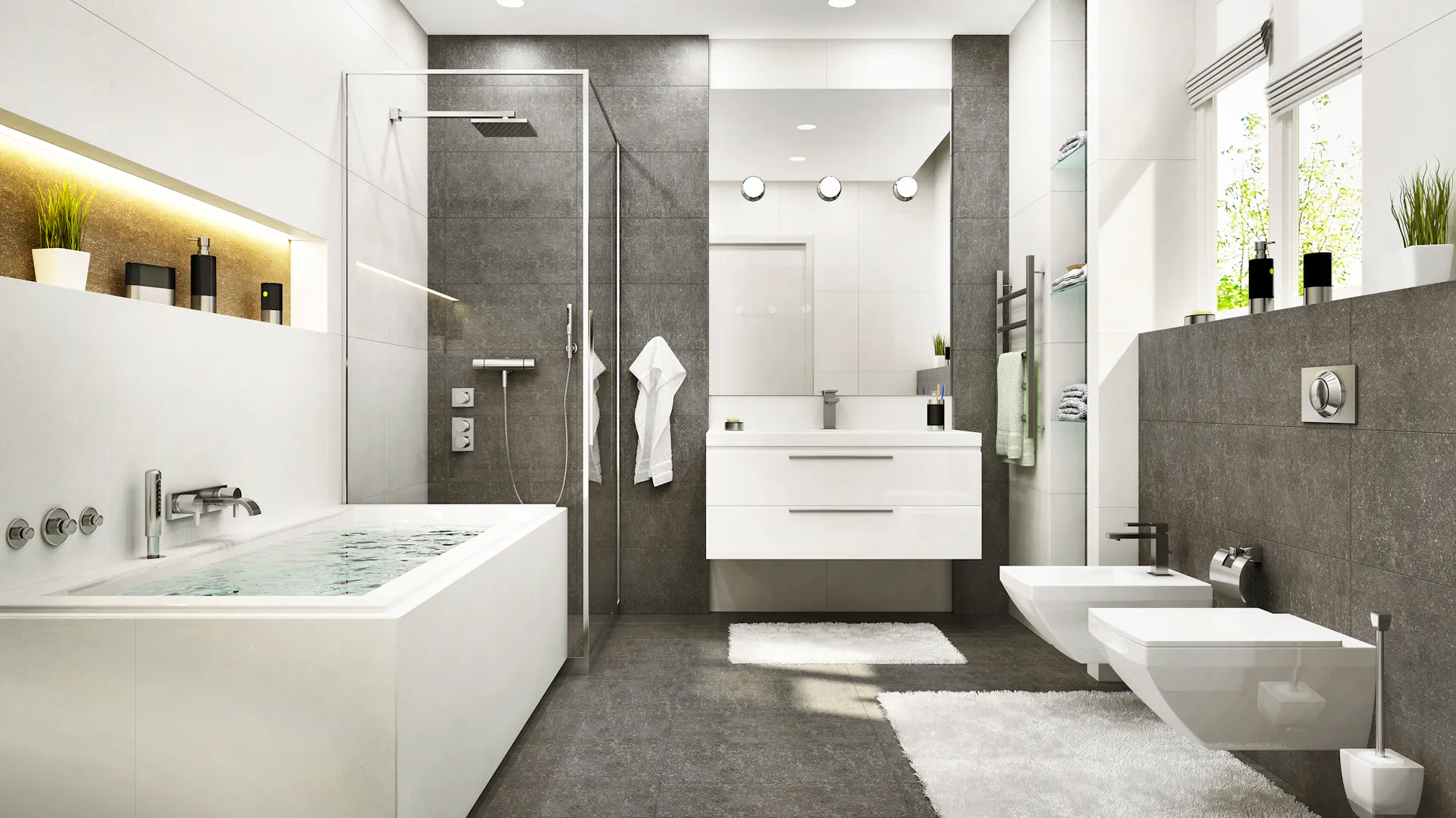 Badezimmer mit grauen Fliesen an Wand und Decke kombiniert mit weißen Möbeln.