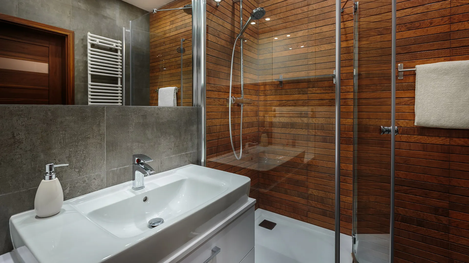Eine Dusche mit Wänden aus dunklem Holz.