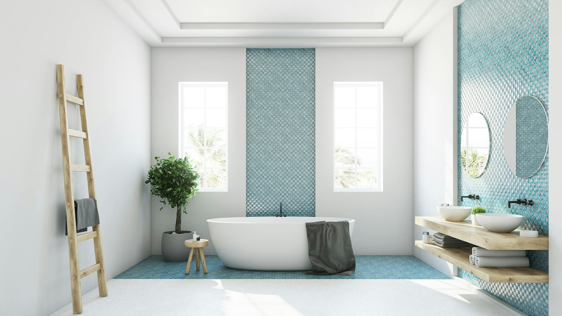 Bagno bianco e blu con vasca indipendente e doppio lavabo.