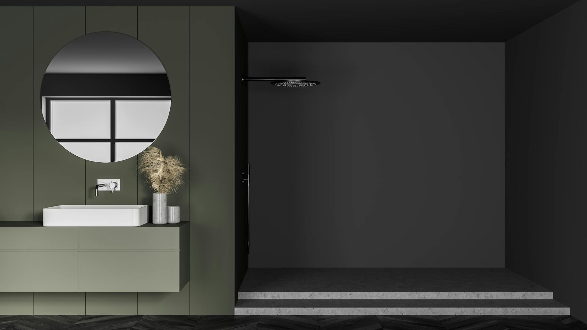 Grünes Badezimmer mit grauer Duschkabine.