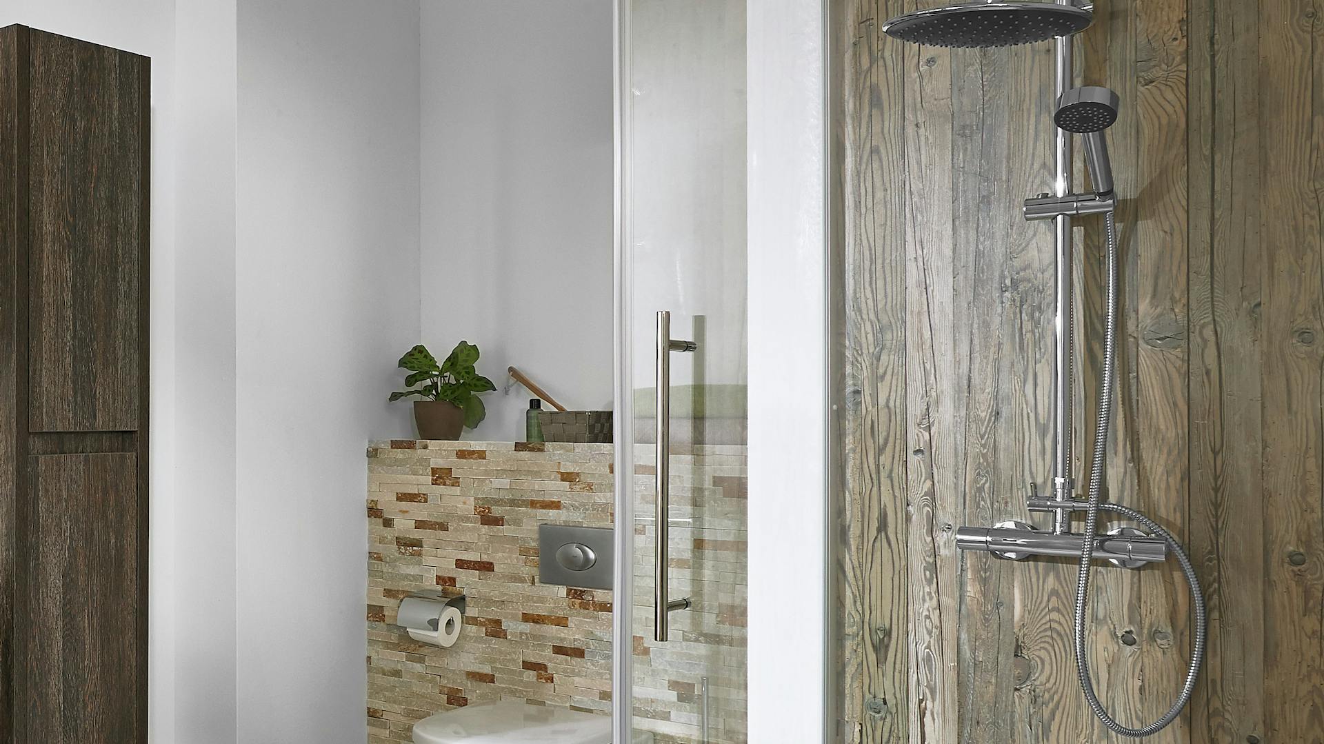 Duschschlauch und Armatur in Dusche mit Wand in Holzoptik.