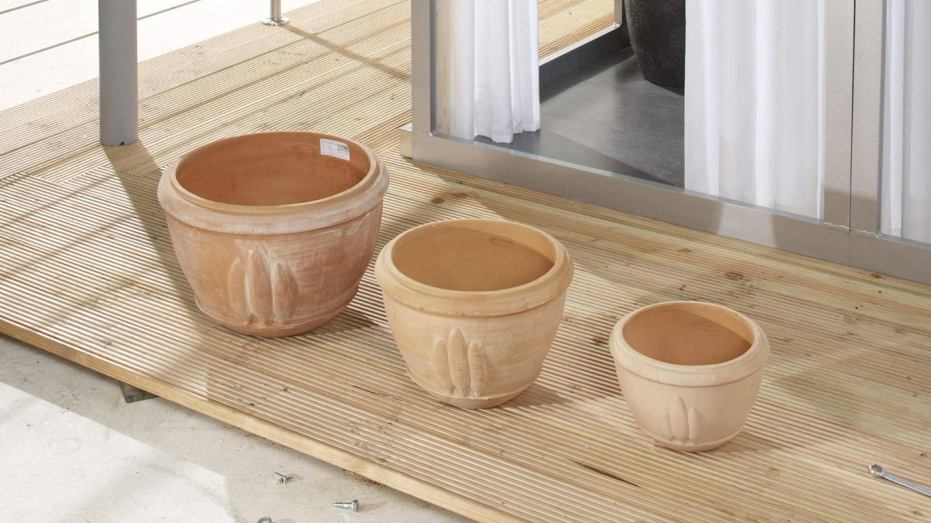 Drei Terrakotta-Töpfe für außen in verschiedenen Größen stehen auf der Veranda.