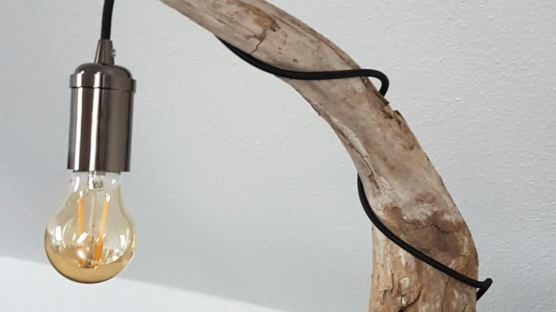 Leuchte an Ast mit Fuß aus Bastelbeton auf Regal