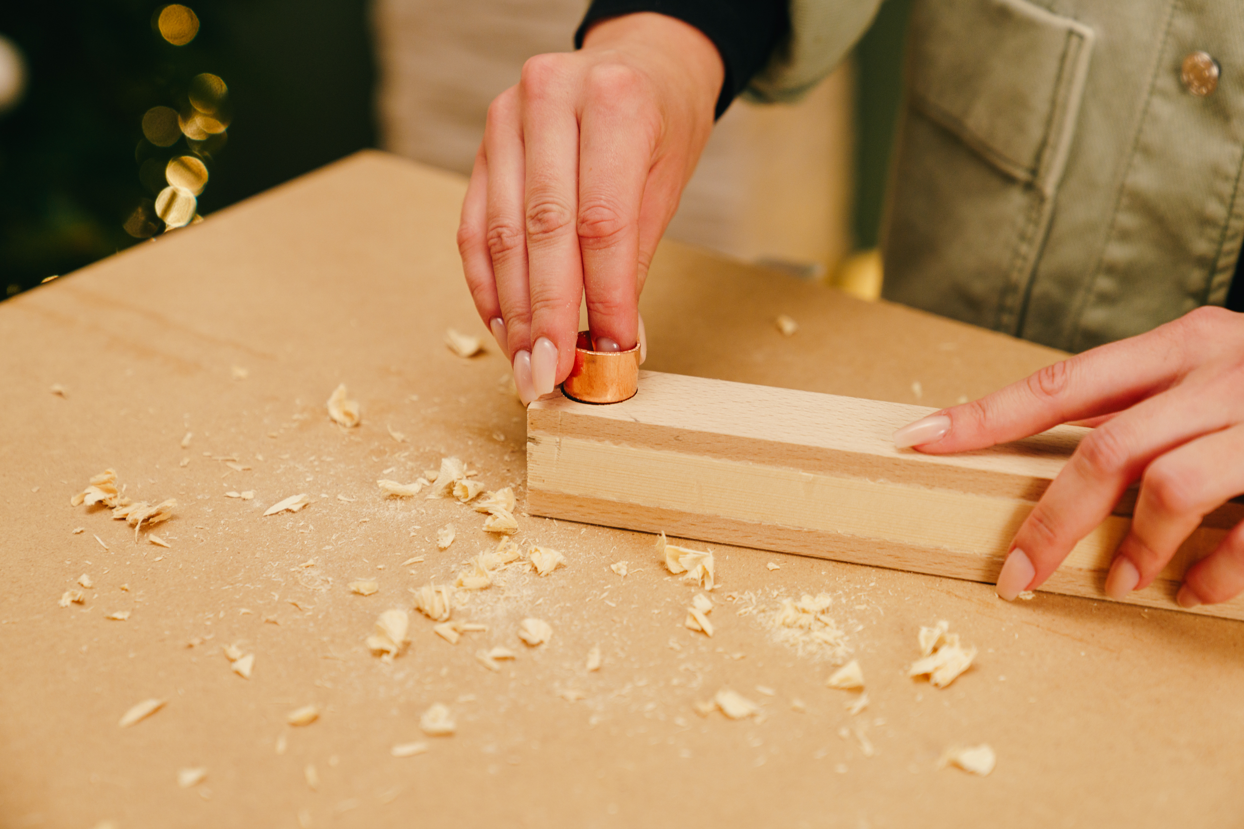 Egy barkácsoló rézcső kupakot tesz a lécszerkezetbe.