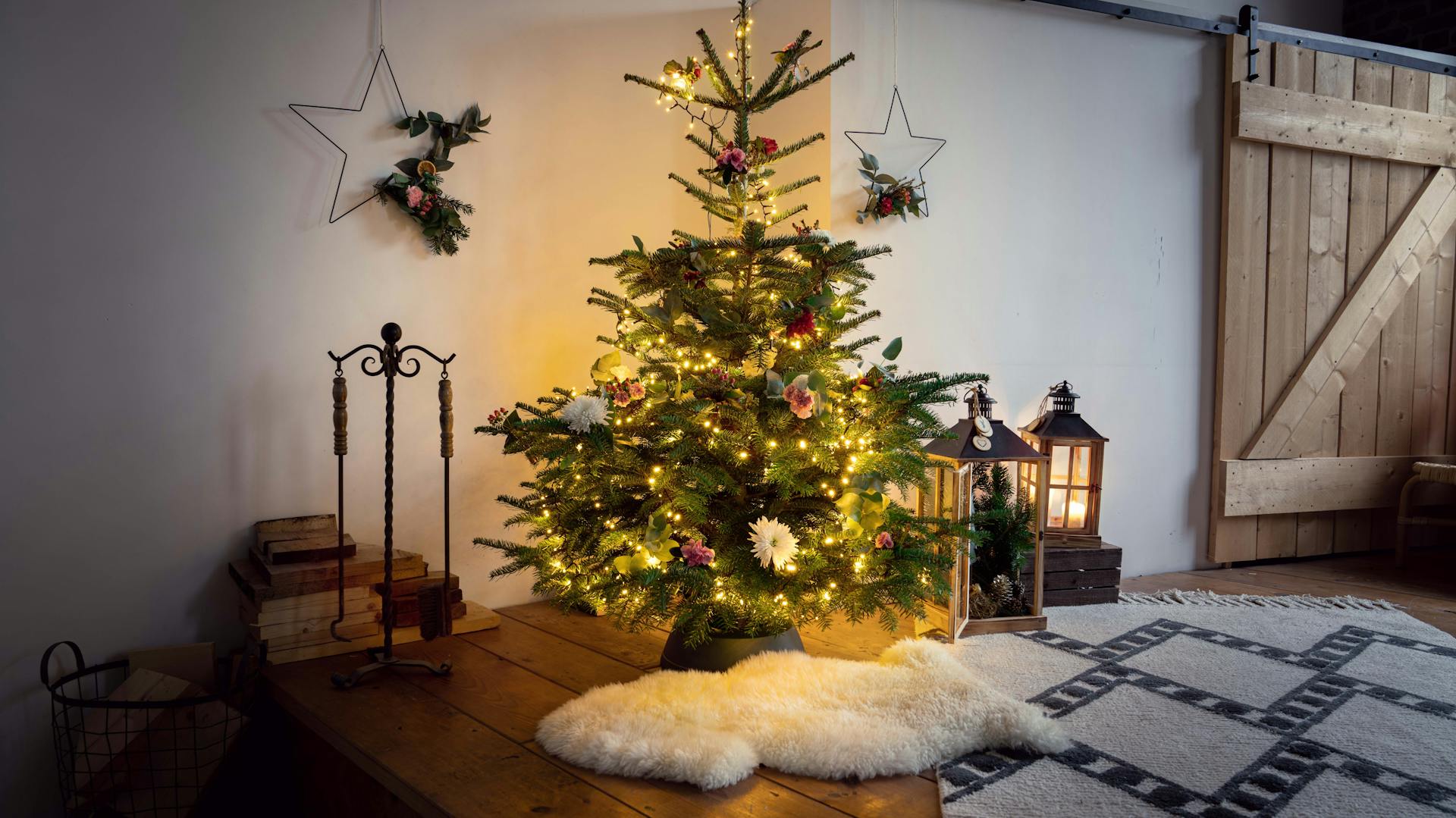Geschmückter und beleuchteter Weihnachtsbaum in Wohnzimmer
