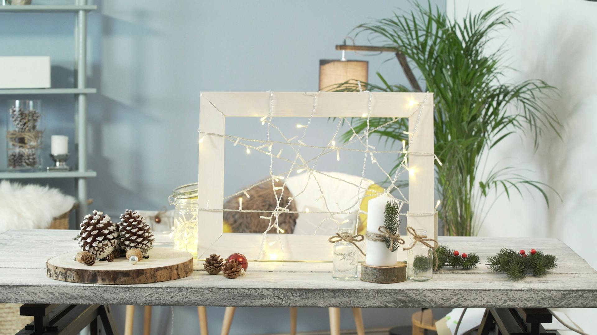 Una cornice luminosa fatta in casa avvolta con una ghirlanda luminosa come decorazione natalizia.