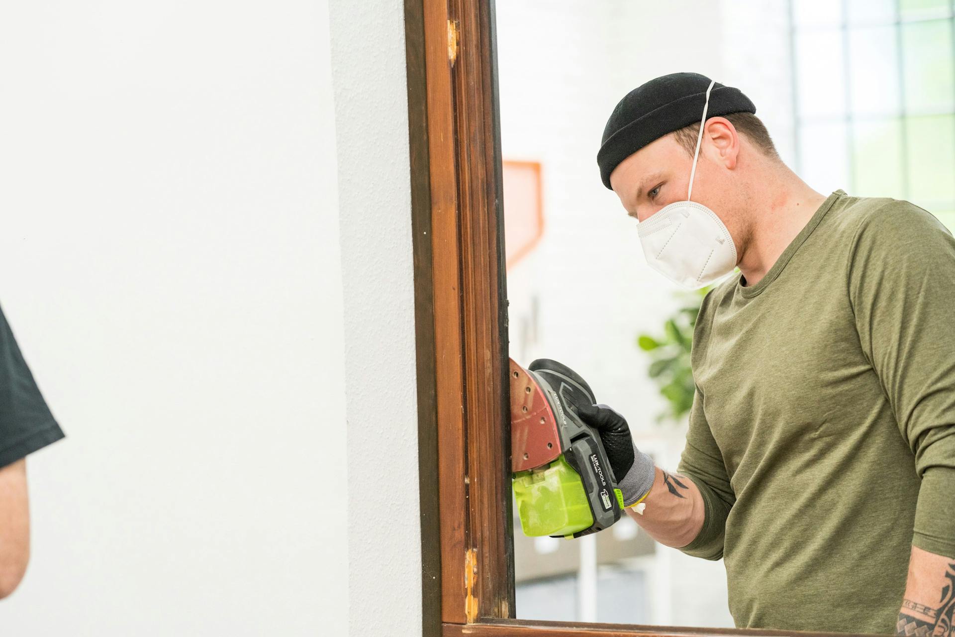 Un amante del fai da te leviga i telai delle finestre.