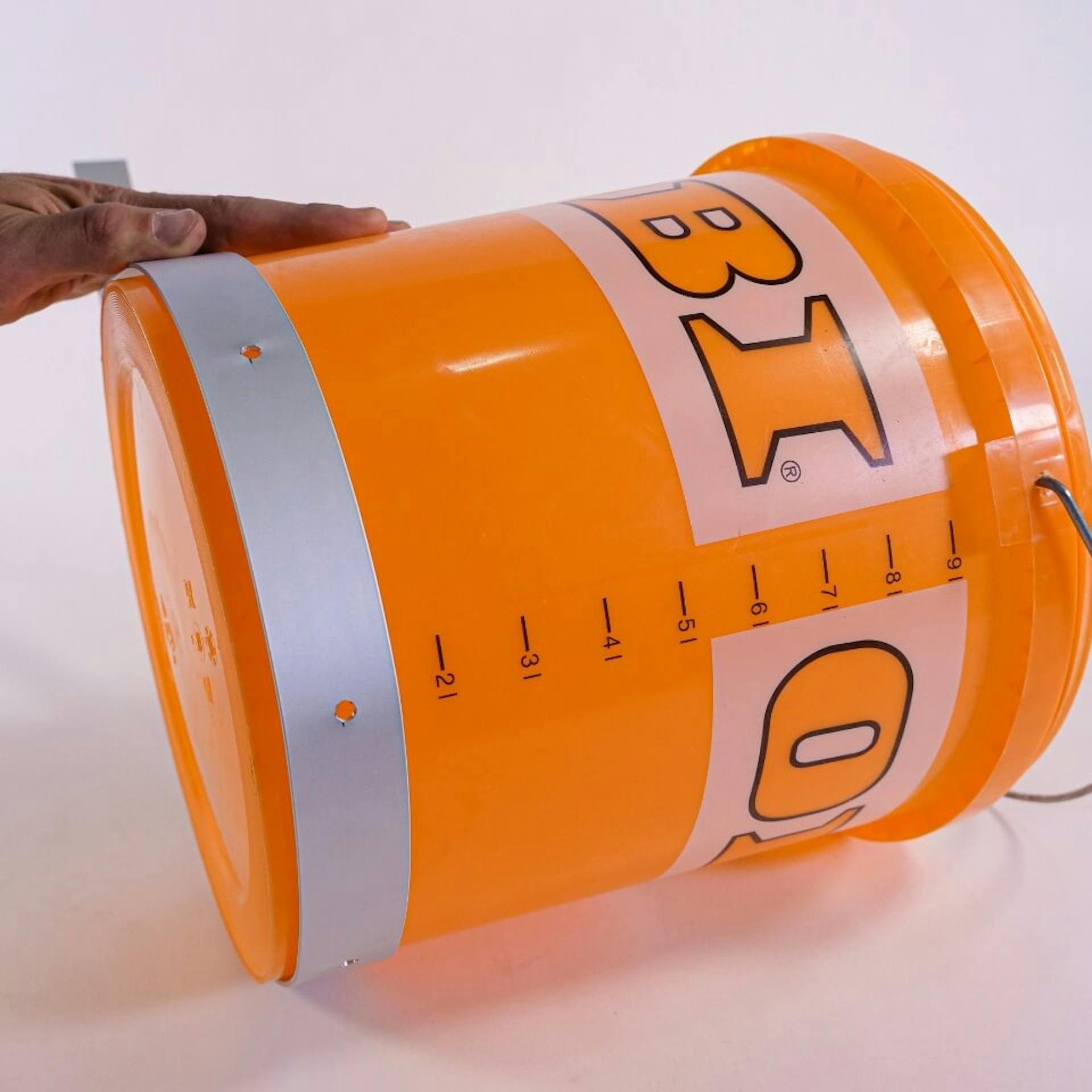 Egy vödör segítségével gyűrűvé formálják az alumíniumszalagot.