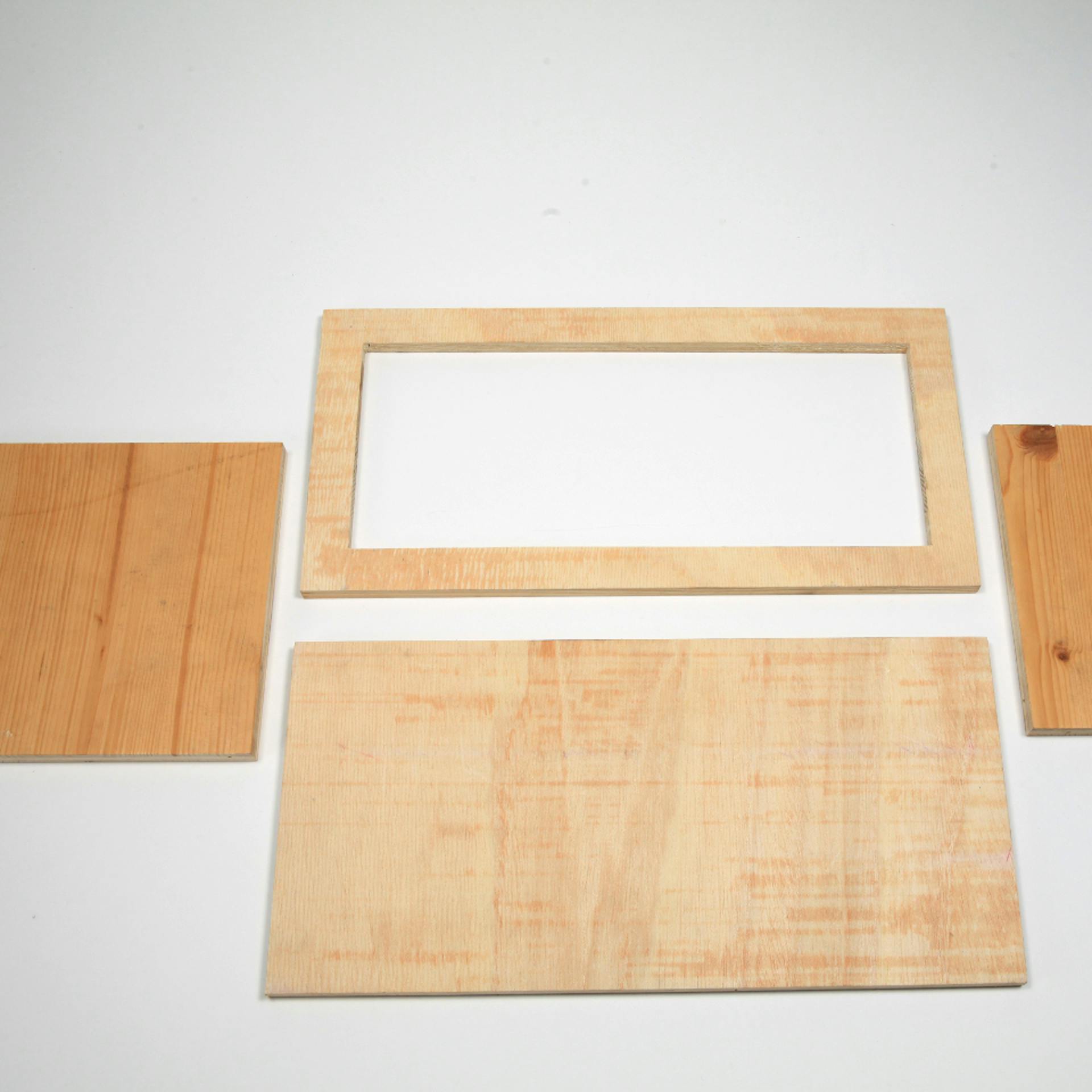 Verschiedene Bretter liegen für das Zusammenbauen einer Zauberbox bereit.