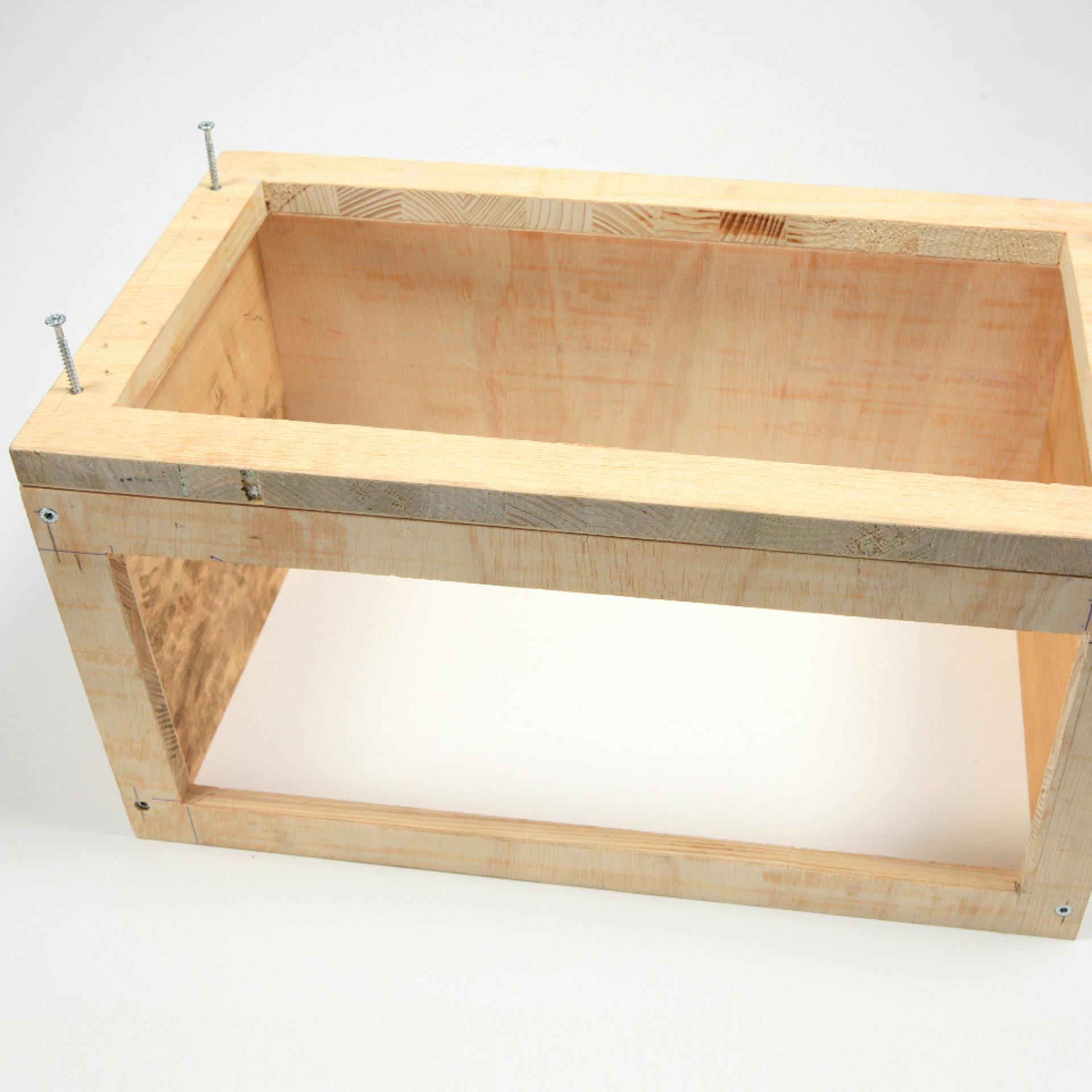 Box mit drei geschlossenen und drei offenen Seiten mit Schrauben darin