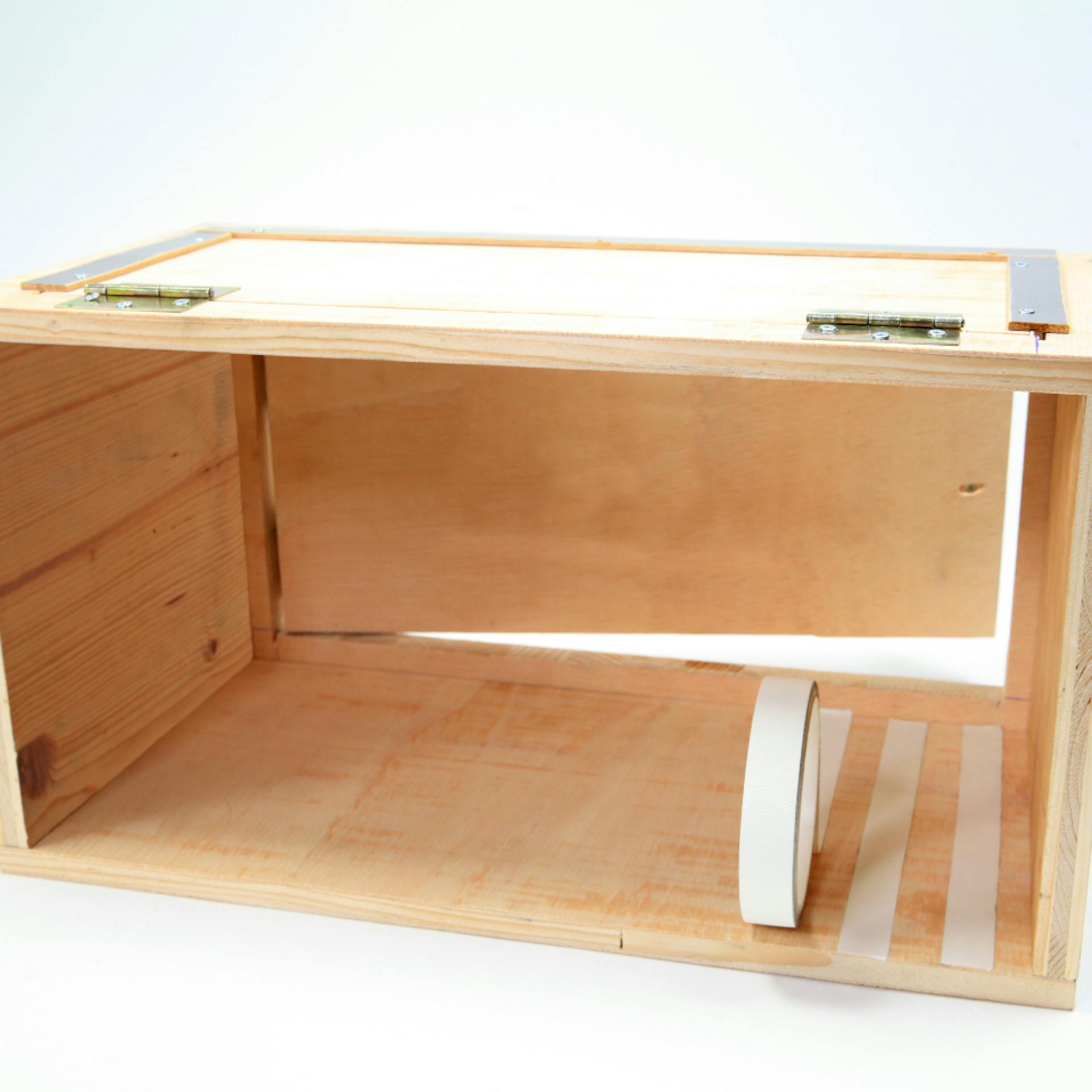 Box aus Holz mit weißen Klebebandstreifen auf Boden