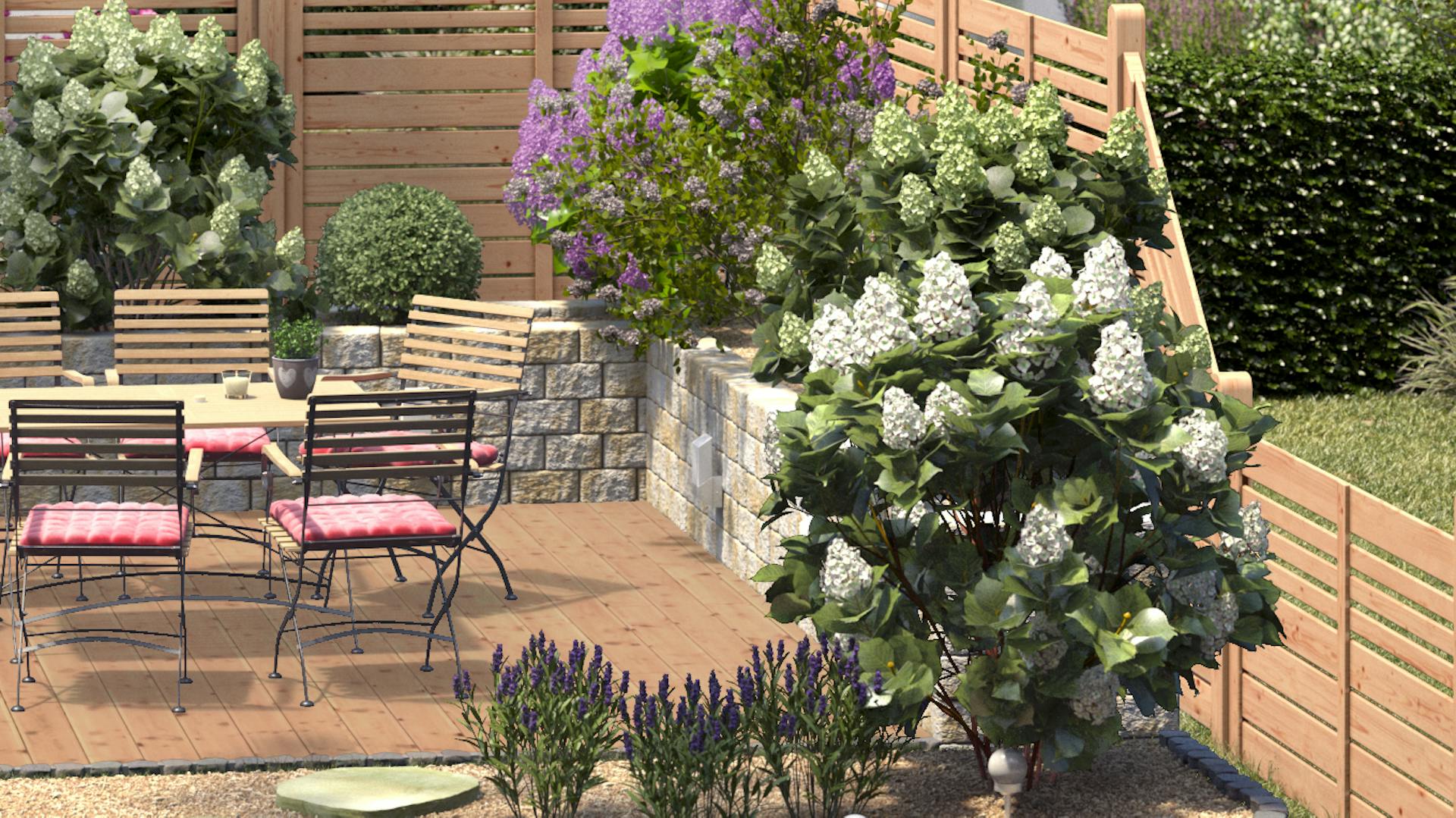 Ideen für die Gartengestaltung romantischer Sitzplatz mit Sitzgruppe aus Metall und Holz an bepflanzten Beeten mit Zierkieseln neben Holzzaun