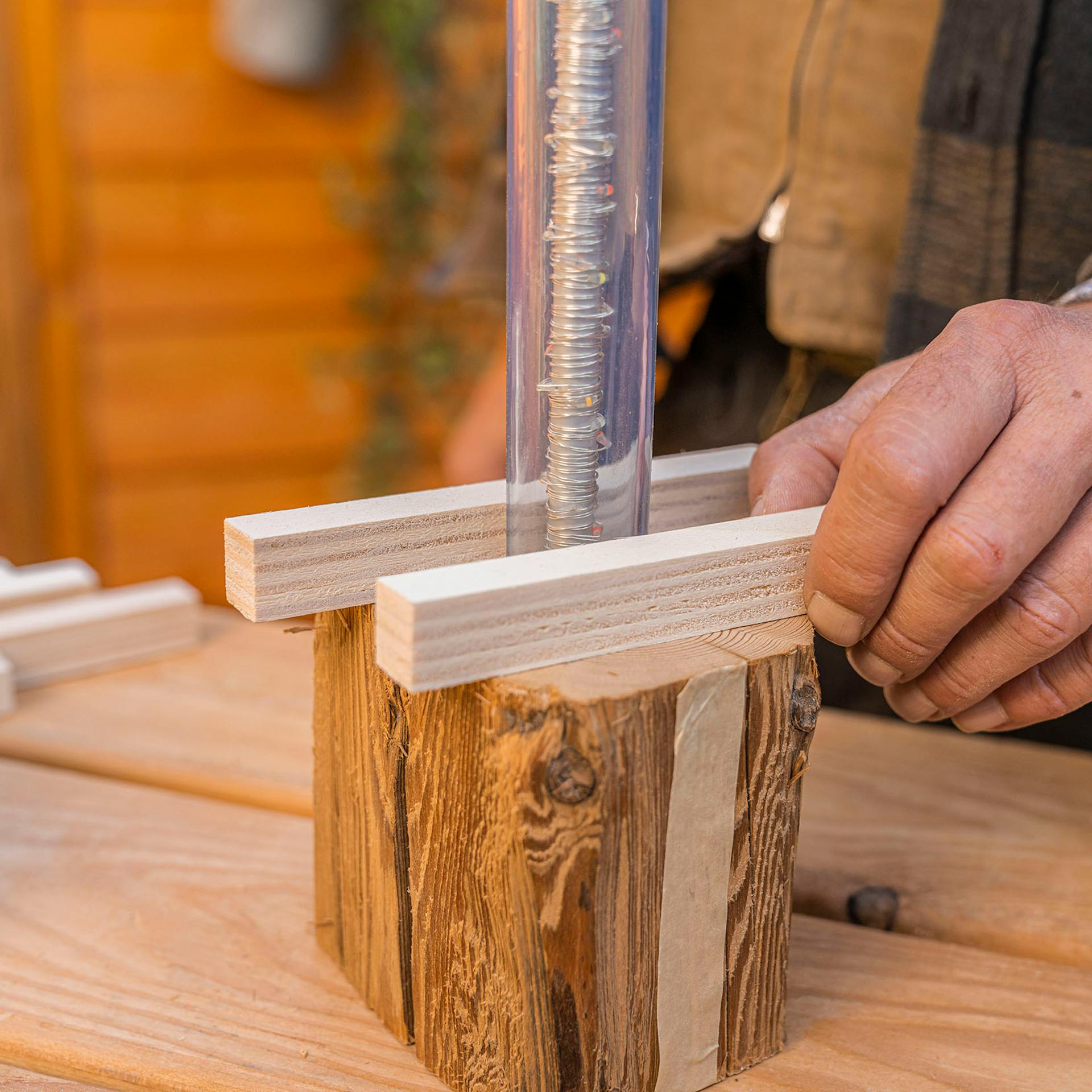 A férfi az első két távtartót a lámpa aljára helyezi.