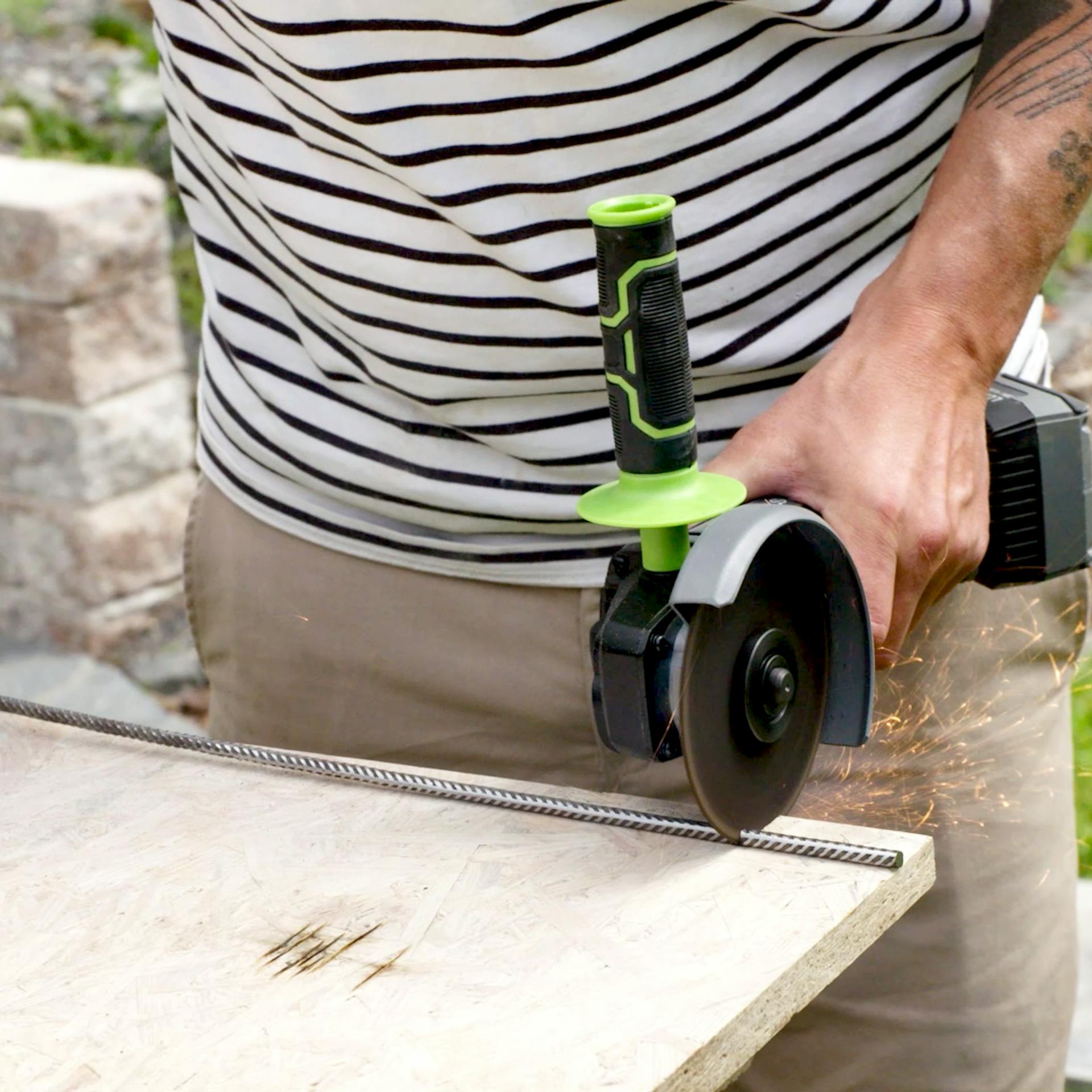 Handwerker schneidet Riffelstahl mit einem Winkelschleifer zu.