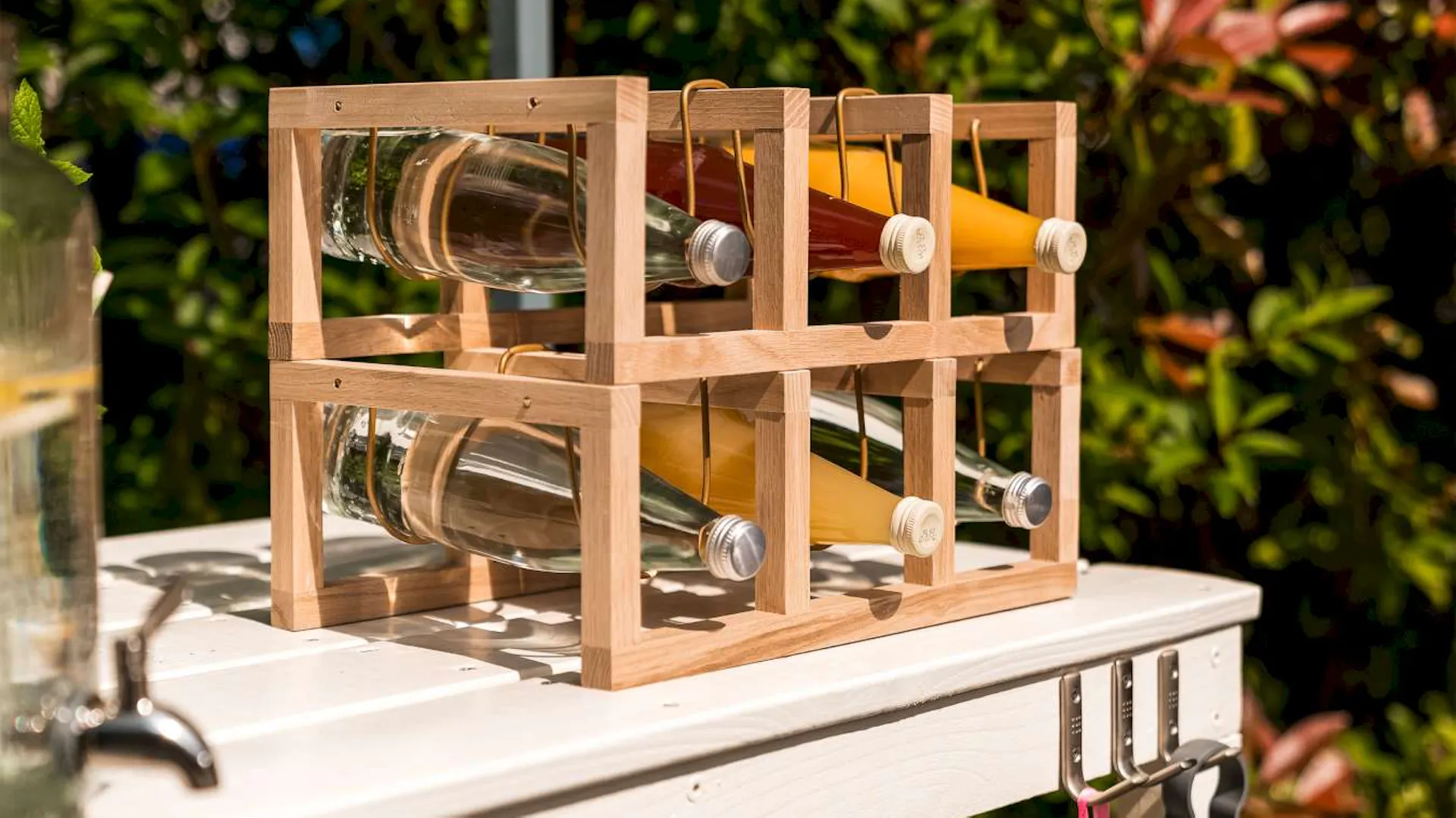 Ein Weinregal aus Holz und Messing, in dem sich Flaschen befinden