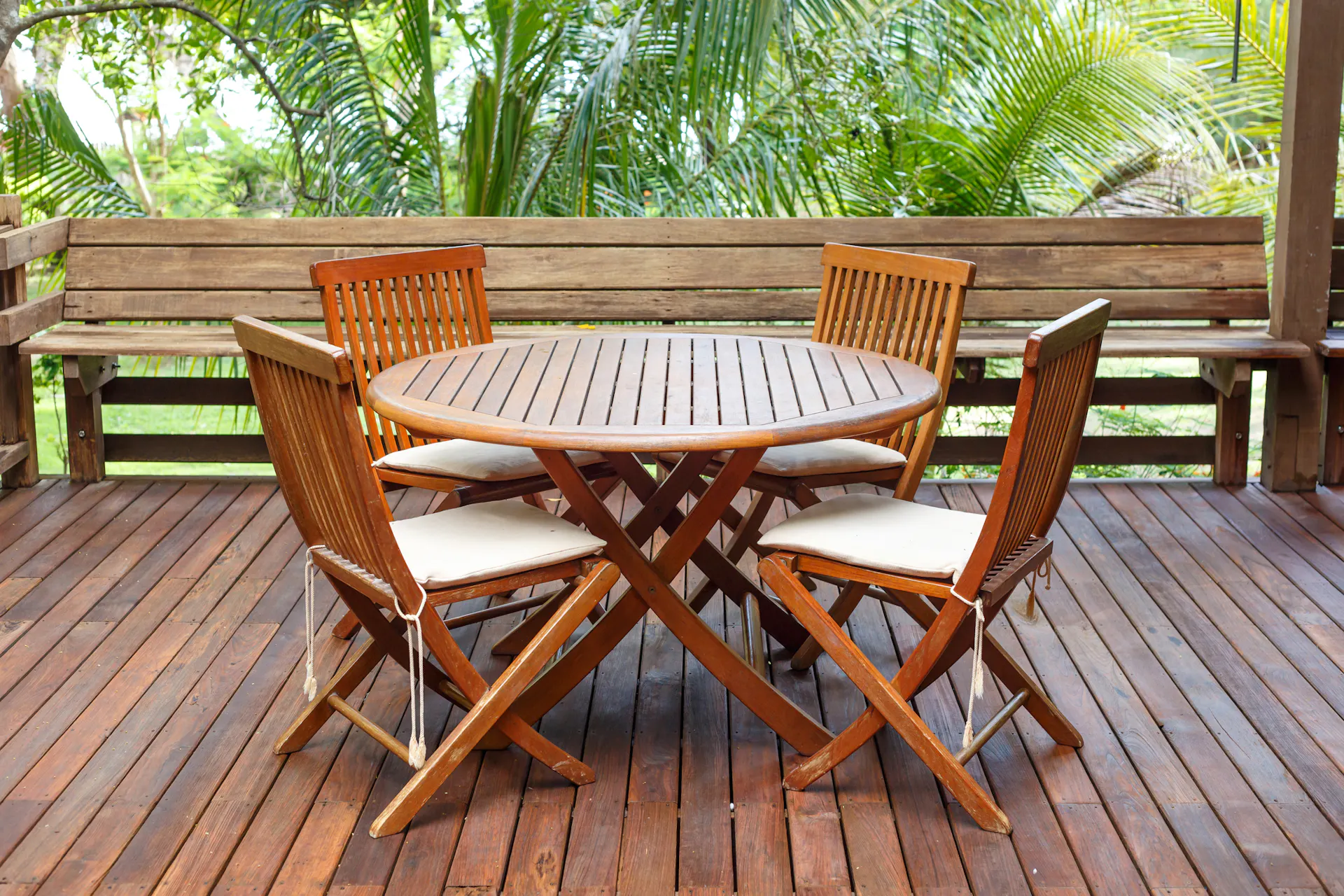 Teakholz-Tisch und -Stühle auf einer hölzernen Terrasse