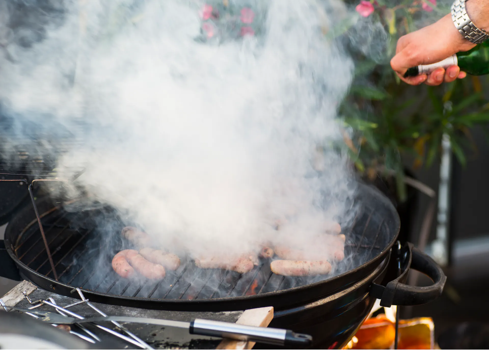 Starke Qualmentwicklung über einem Grill.