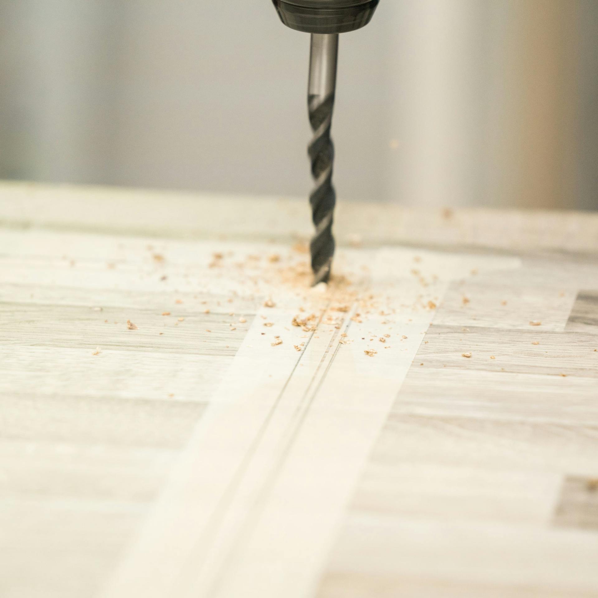 Domáci majster vŕta otvory do rohov pracovnej dosky