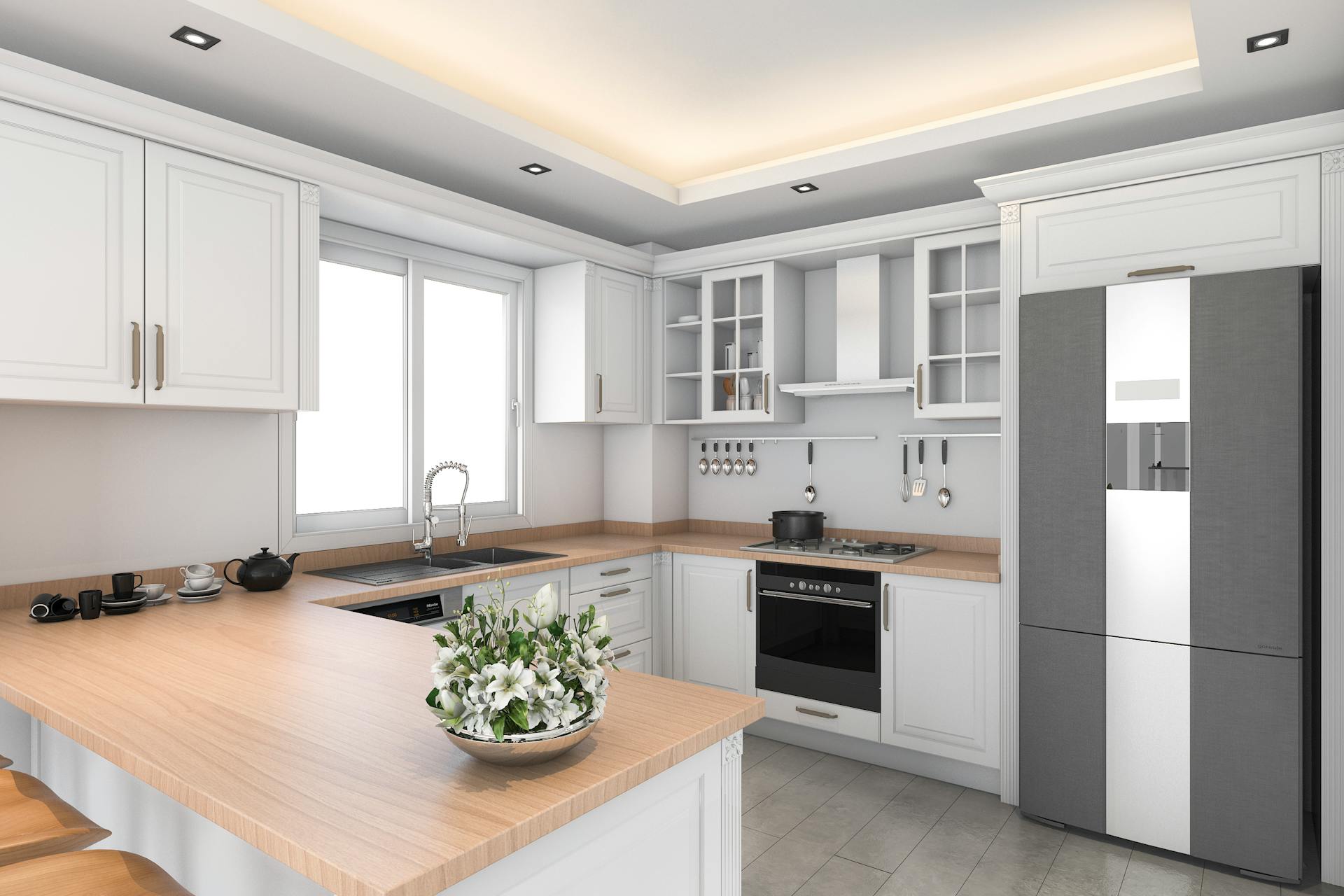 Cucina a forma di U con faretti da soffitto come illuminazione di base