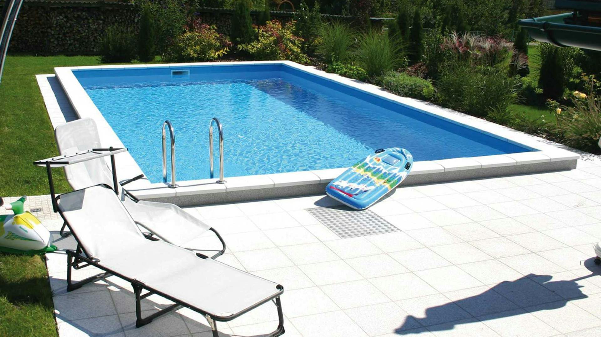 Pool im Garten mit Liegestuhl und Wasserspielzeug.