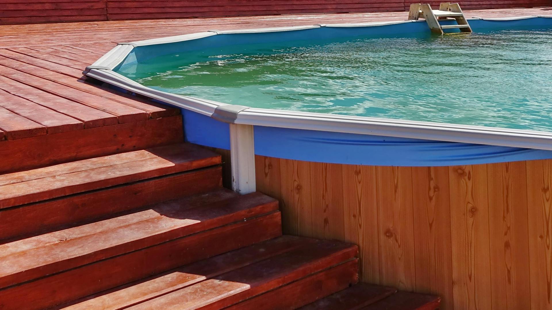 Eine außenliegende Pooltreppe aus Holz.