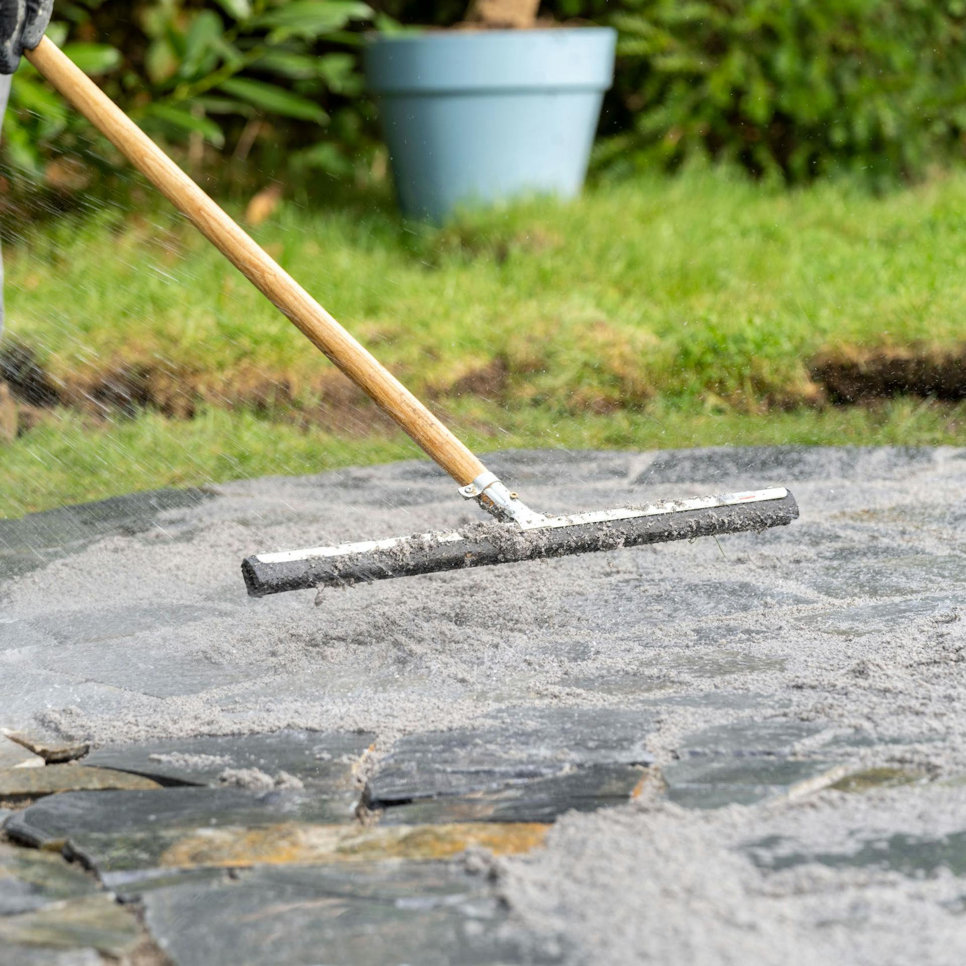 Muž drží na terase gumovú stierku