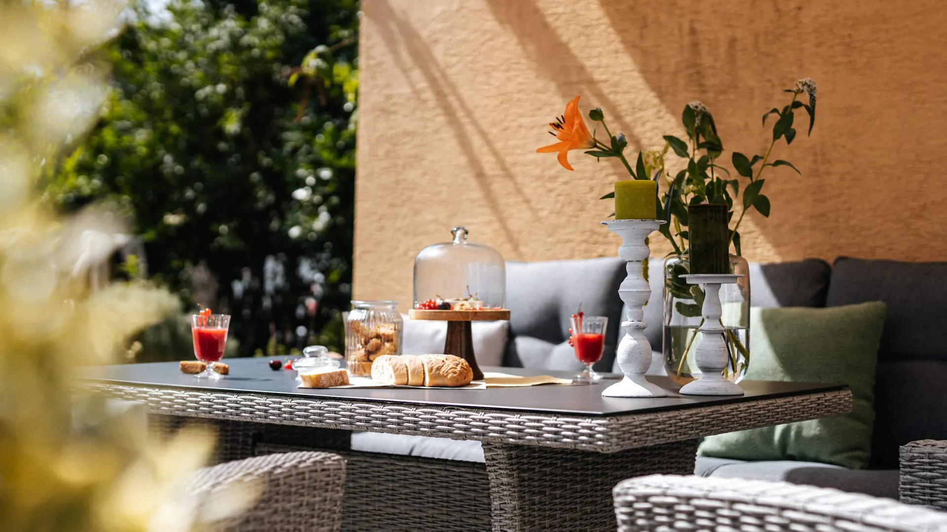 Gartentisch mit Blumen, Essen und Getränken
