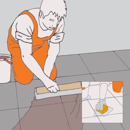 Qualcuno sta spargendo la malta per fughe sulle piastrelle.