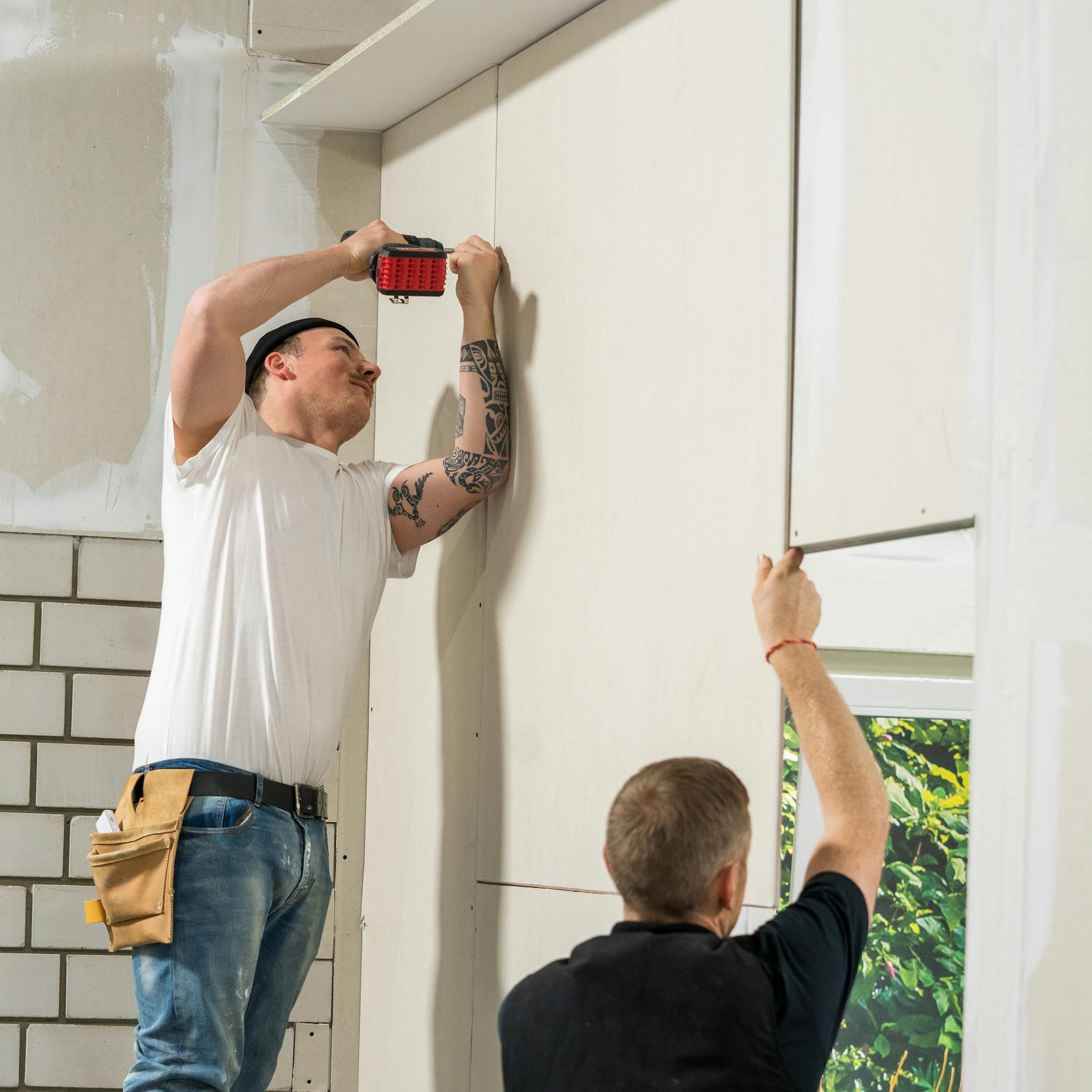 Handwerker bringt die zweite Beplankung an.