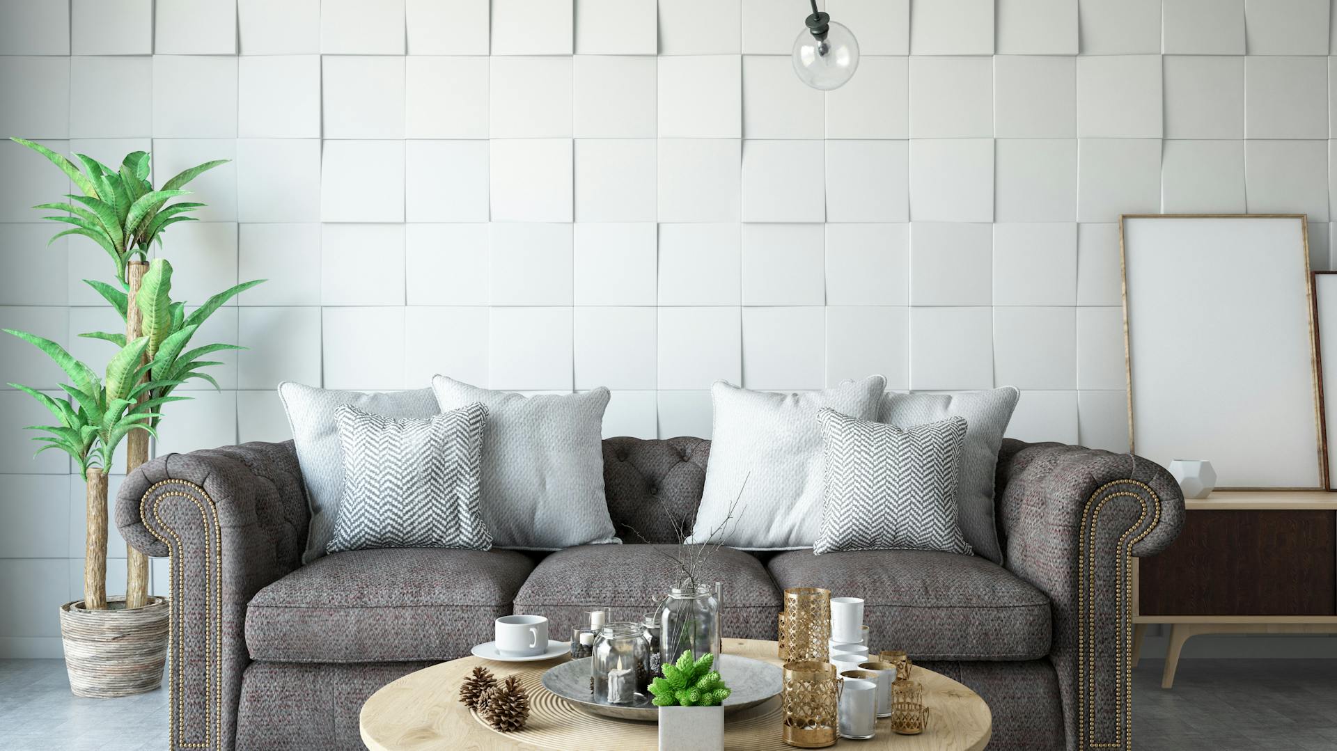 Eine 3D-Tapete im Wohnzimmer hinter einem grauen Sofa