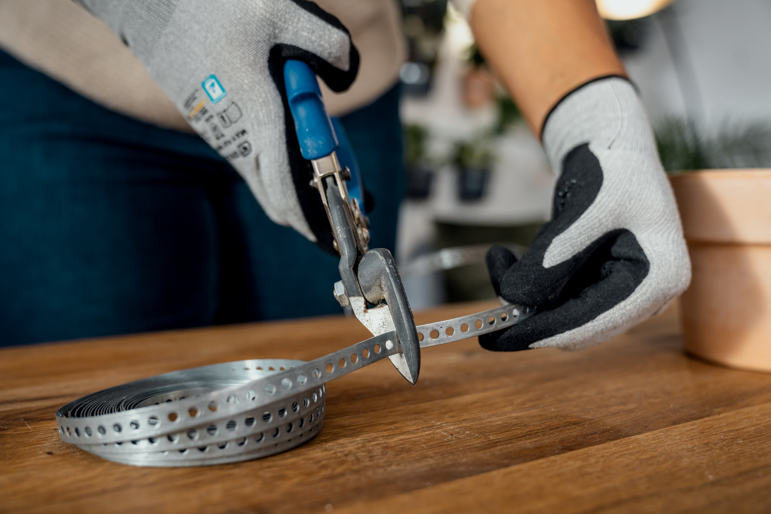 Taglio su misura del nastro perforato con una cesoia per lamiera.