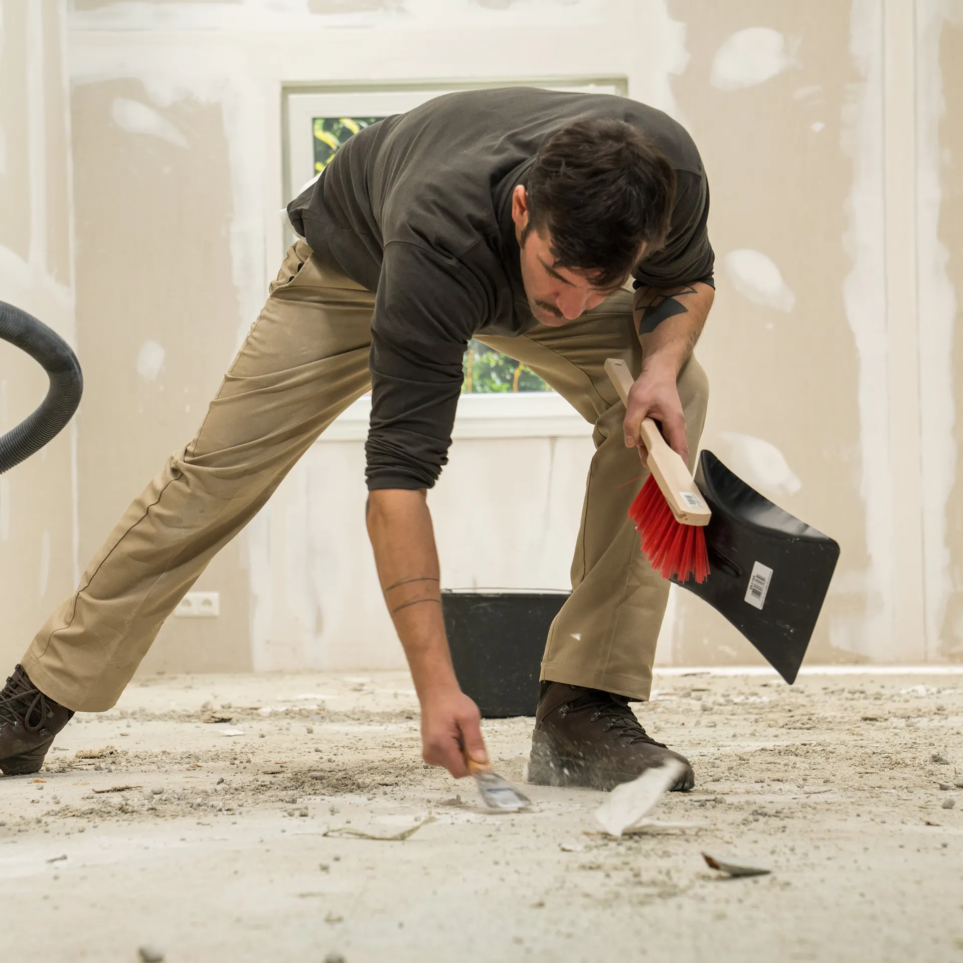 Heimwerker befreit Untergrund von losen Materialien.