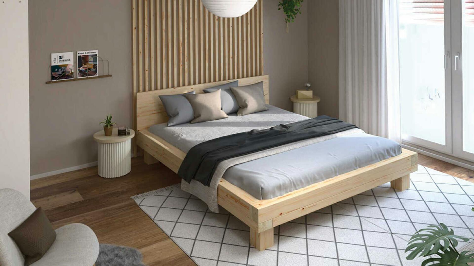 Ein Schlafzimmer mit hellen und gräulichen Wänden im Japandi Stil.