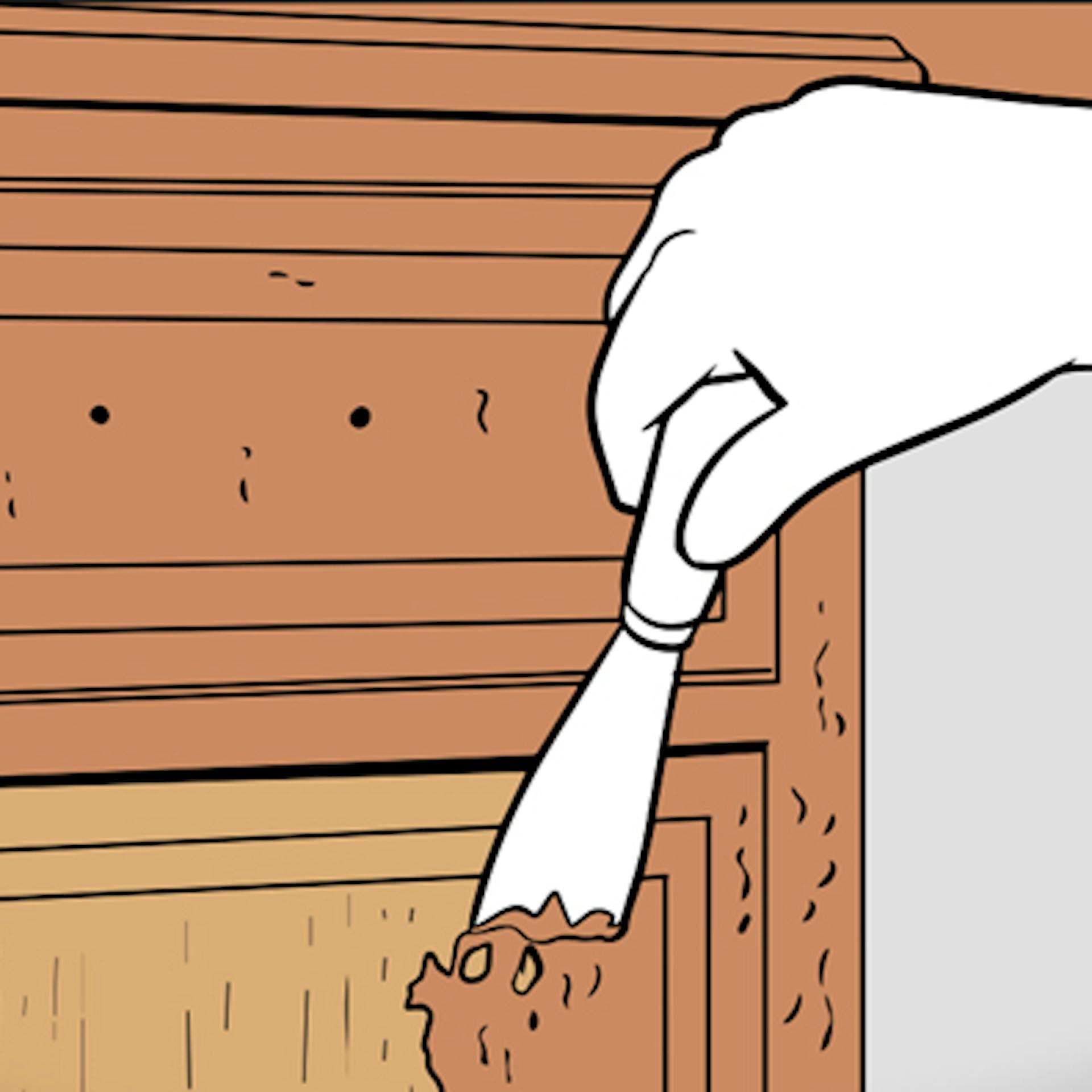 Hand mit Spachtel auf Holzmöbel zum Abbeizen
