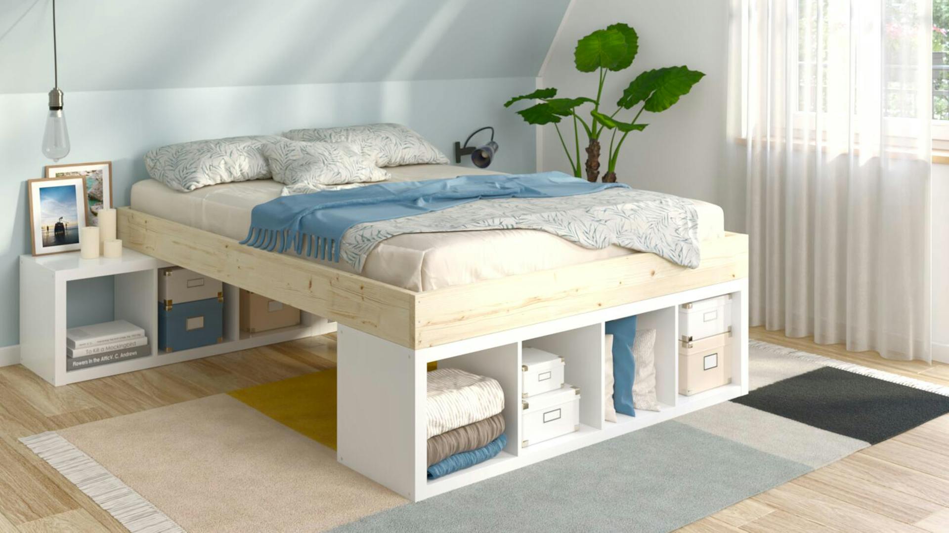 Bett mit Stauraum in hellem Schlafzimmer mit blauer Wand