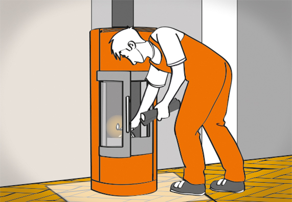 Egy ember gyújtóst helyez be a kandallókályhába és első alkalommal befűt.