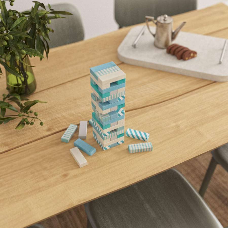 Ein mit hellblauen Mustern bemaltes Jenga liegt auf einem Tisch