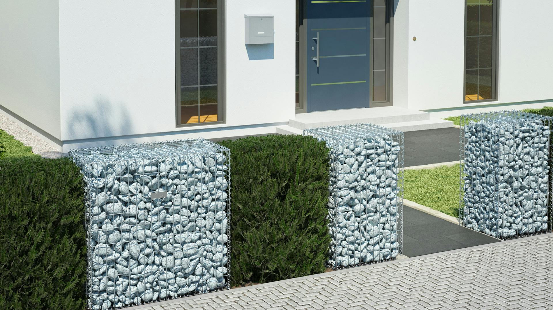 Ein Vorgarten mit einem Sichtschutz in Form einer weißen Gabione in Kombination mit einer Hecke.