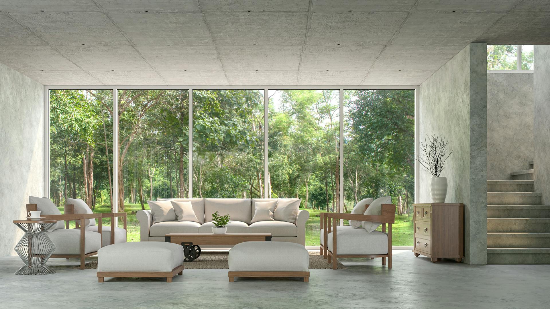 Sitzecke in einer Wohnung, die mit einem Boden, Wänden und einer Decke aus Beton gestaltet ist