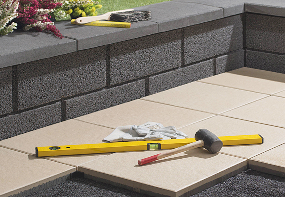 Wasserwaage und Hammer auf Fliesen