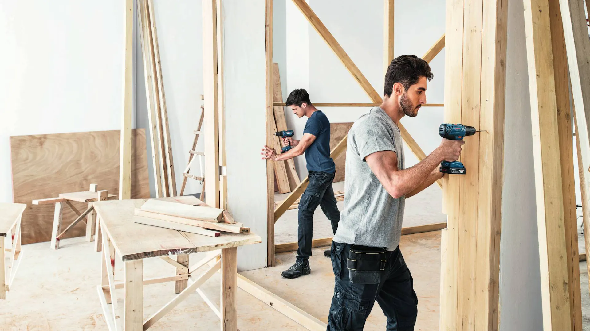 Handwerker mit Werkzeugen und Holzbrettern beim Innenausbau