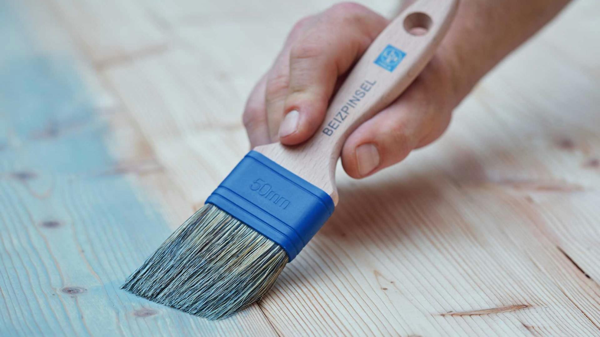 Il legno viene sverniciato con un pennello per sverniciatura e uno sverniciatore blu.