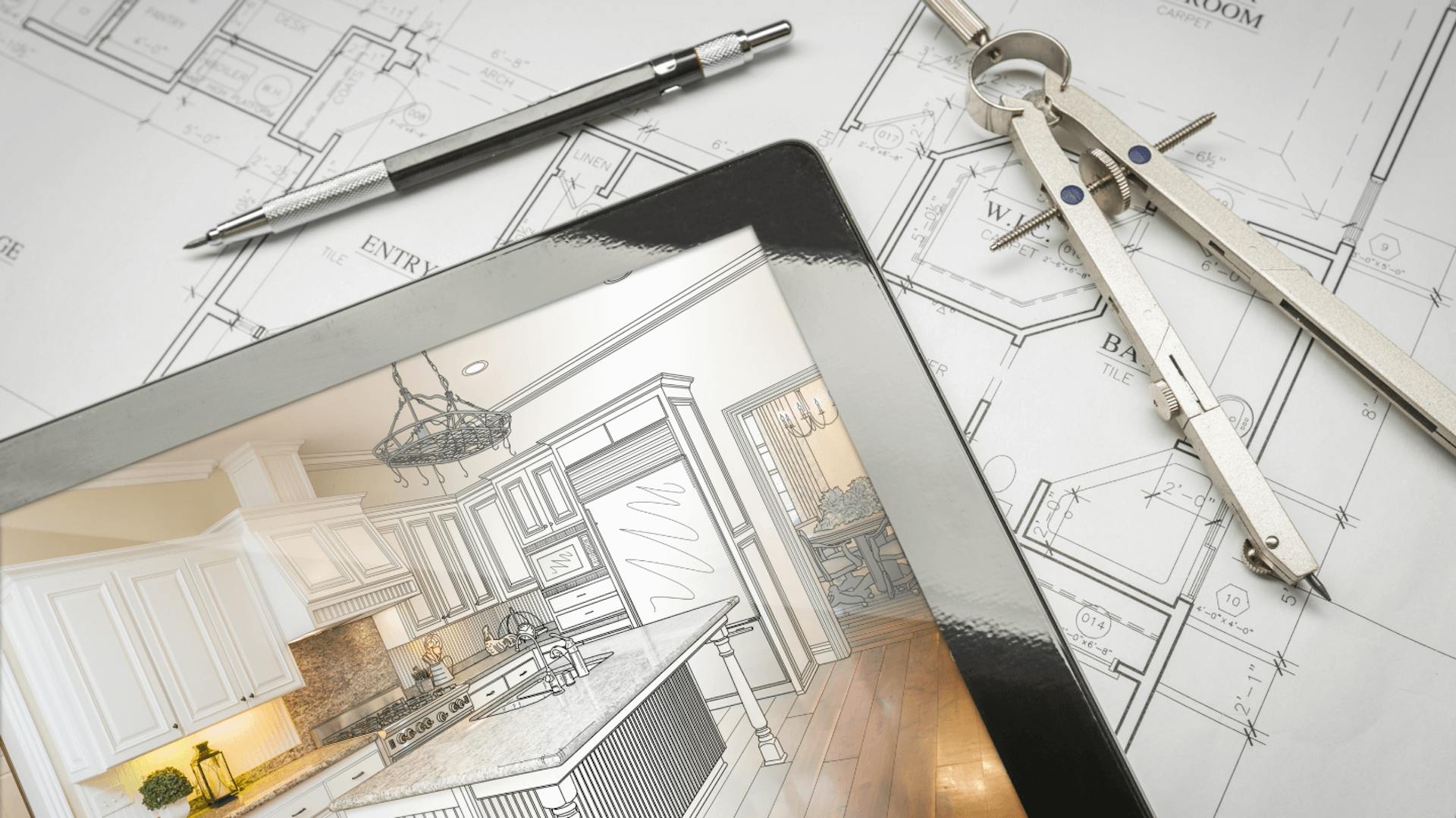 Ein Küchengrundriss, auf dem ein Tablet und Messwerkzeuge liegen.