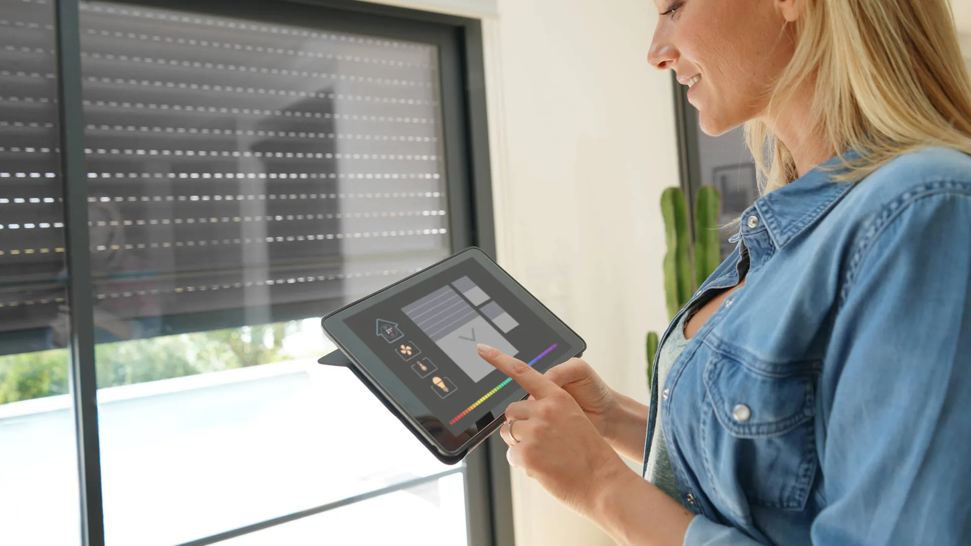 Kobieta z tabletem korzystająca z systemu automatyki domowej