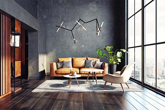 Nowoczesny salon z panoramicznym oknem. W centralnym miejscu wisząca lampa o geometrycznej formie.
