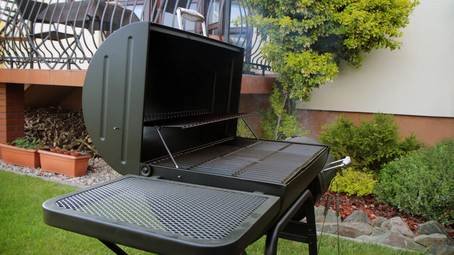 Grill elektryczny na taras wyposażony jest w stojak i wędzarnię