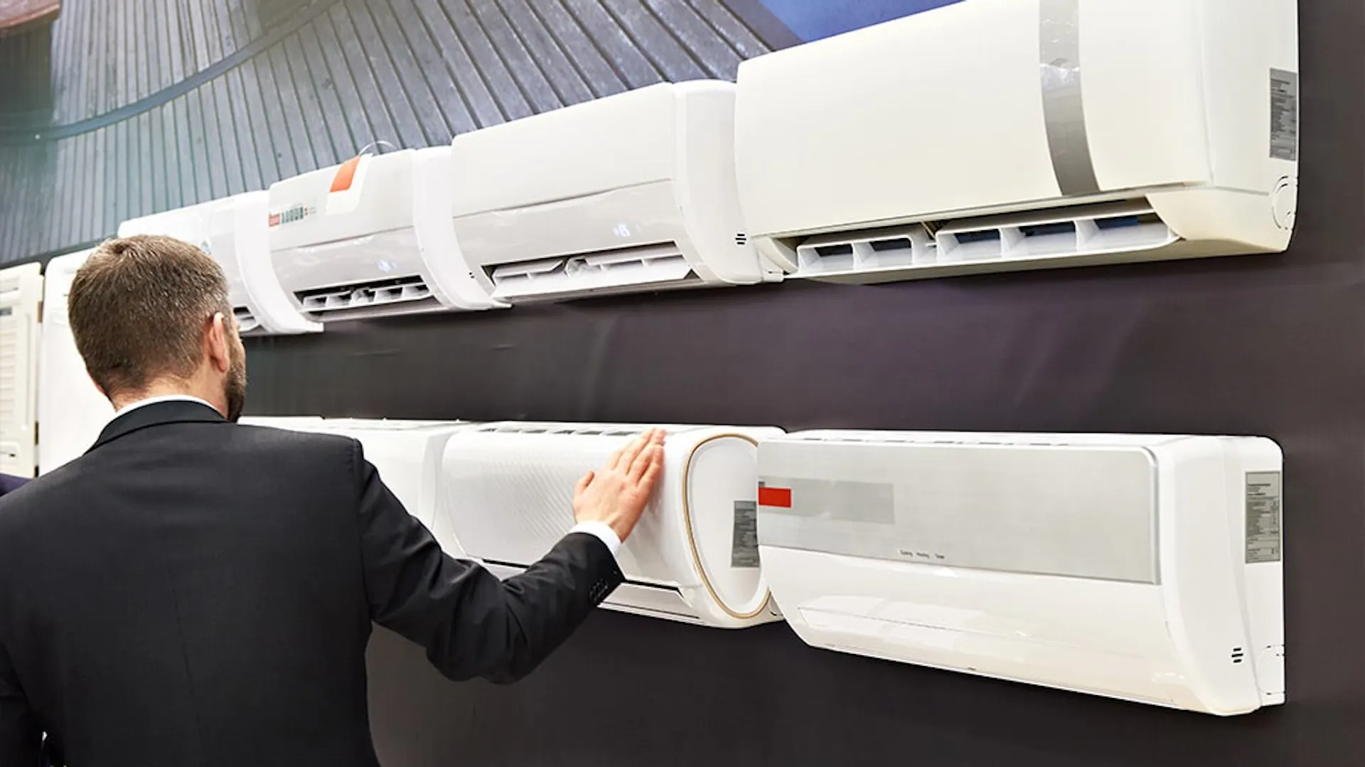 Mężczyzna w sklepie wybiera klimatyzator do mieszkania