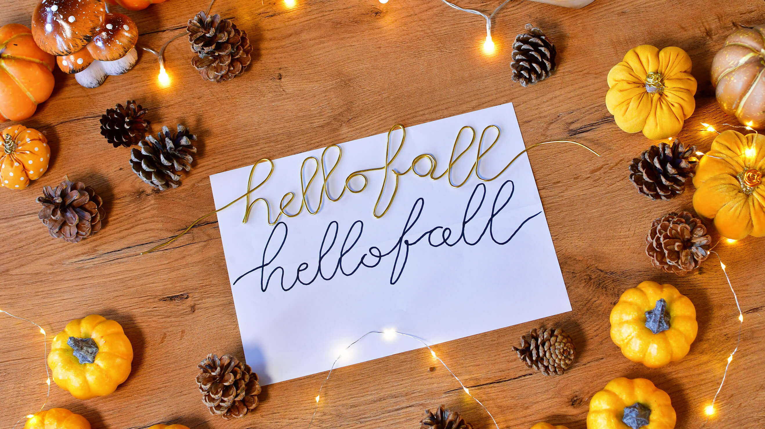 Samodzielnie wykonany ze złotego drutu napis hello fall - element mający zwieńczyć kompozycję jesiennej dekoracji - wianka na drzwi diy.